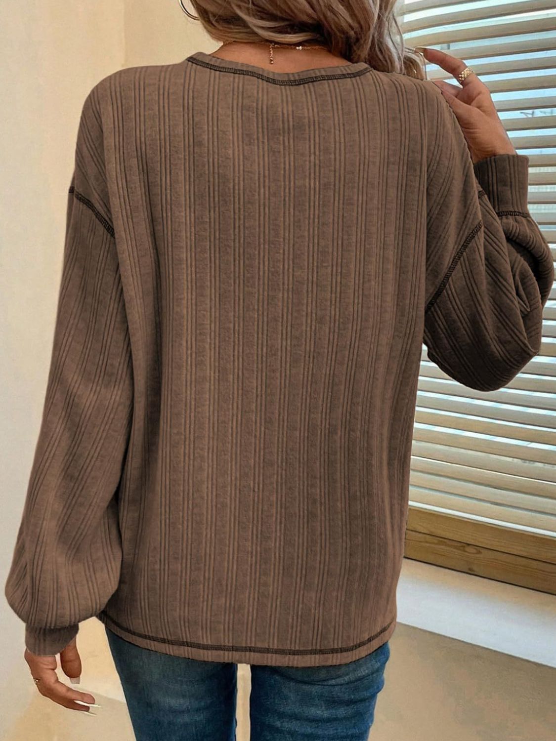 Dust Storm ribbed knit top with contrast stitching and balloon sleeves.