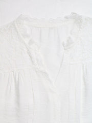 White lace-trimmed V-neck maternity blouse with delicate fabric details