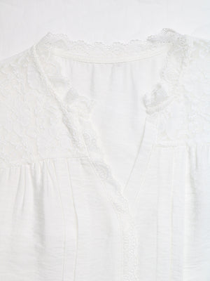 White lace-trimmed V-neck maternity blouse with delicate fabric details
