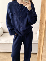 Dark blue ribbed knit cardigan and wide leg pants set with button closure and chest pocket.