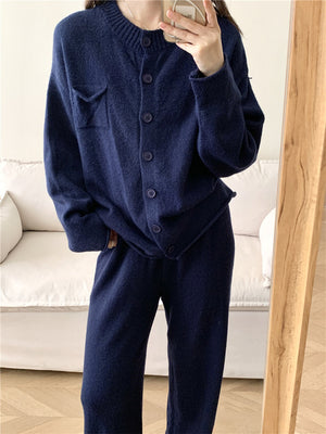 Dark blue ribbed knit cardigan and wide leg pants set with button closure and chest pocket.