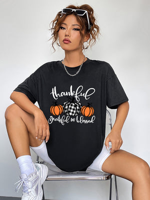 Black oversized graphic tee with thankful pumpkins and text, crew neck, short sleeves.