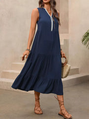 Navy midi dress with ruffled hem and white lace trim V-neck, sleeveless, tiered skirt.