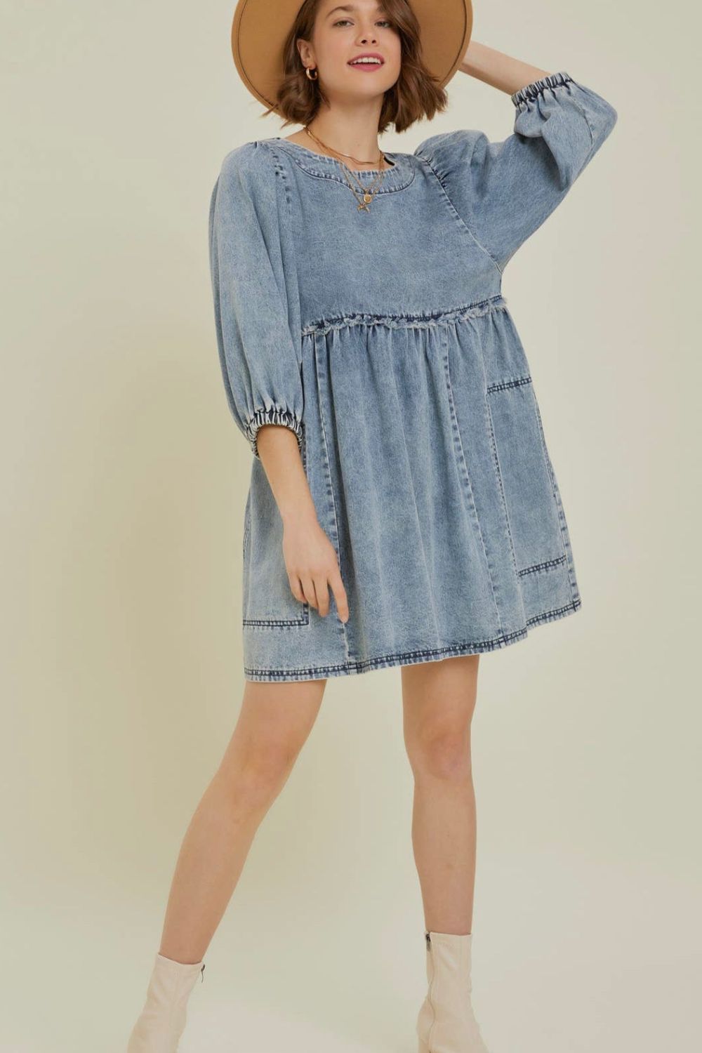 Gathered waist denim mini dress in medium wash with balloon sleeves and ruffled tiers.