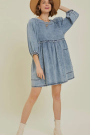 Gathered waist denim mini dress in medium wash with balloon sleeves and ruffled tiers.