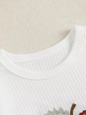 White ribbed cotton baby bodysuit with apple embroidery detail.