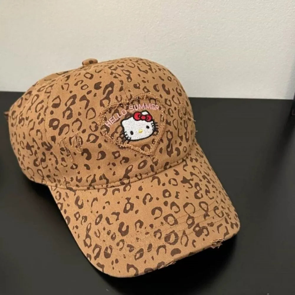 Brown leopard print baseball hat with embroidered Hello Kitty and "Hello Summer" detail.
