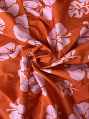 Orange and pink floral print polyester ruffled crop top and maxi skirt set fabric detail.