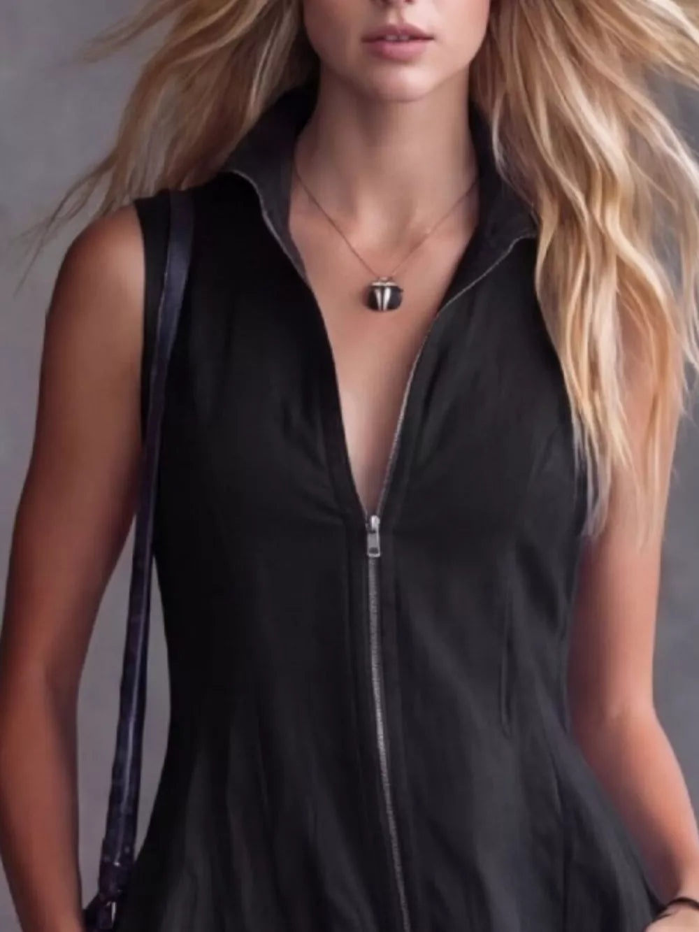 Black sleeveless high-low ruffled dress with zipper neckline and collar.
