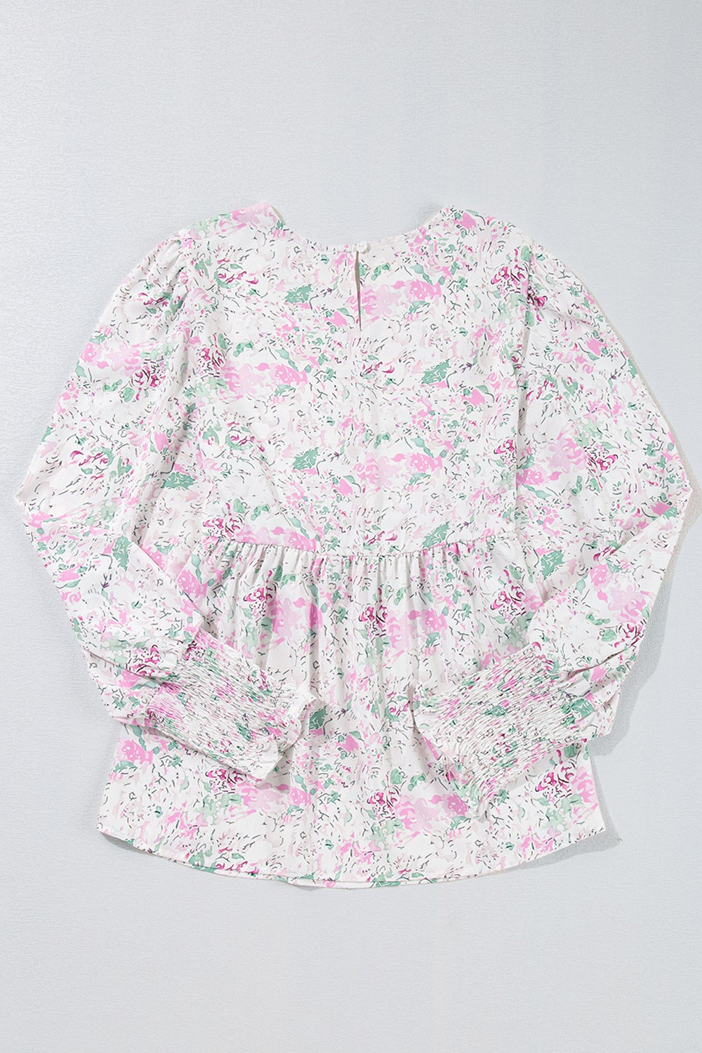 Blush pink floral print blouse with smocked waist and cuffs