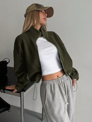 Olive fleece cropped funnel neck jacket with drawstring hem, styled with a white crop top.