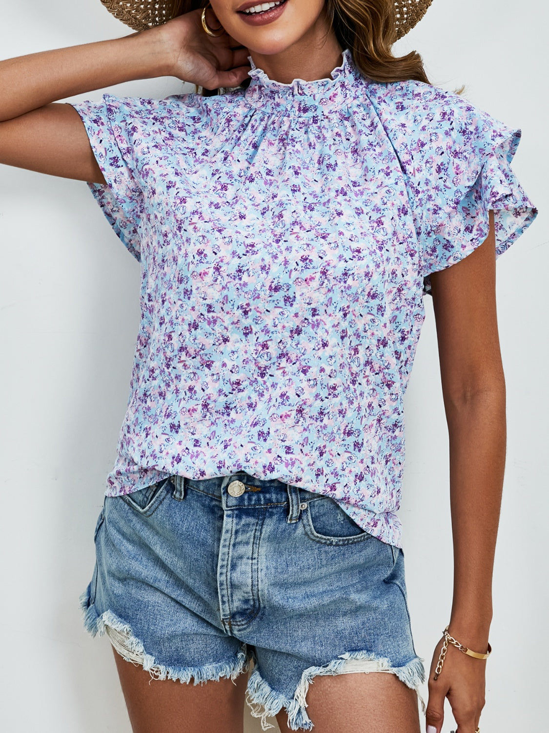 Light blue floral blouse with ruffled neckline and flutter sleeves