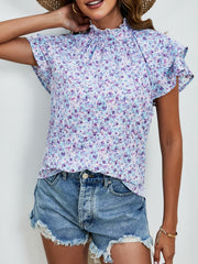 Light blue floral blouse with ruffled neckline and flutter sleeves