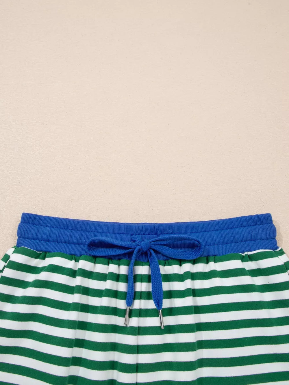 Green and white striped cotton shorts with blue drawstring waist