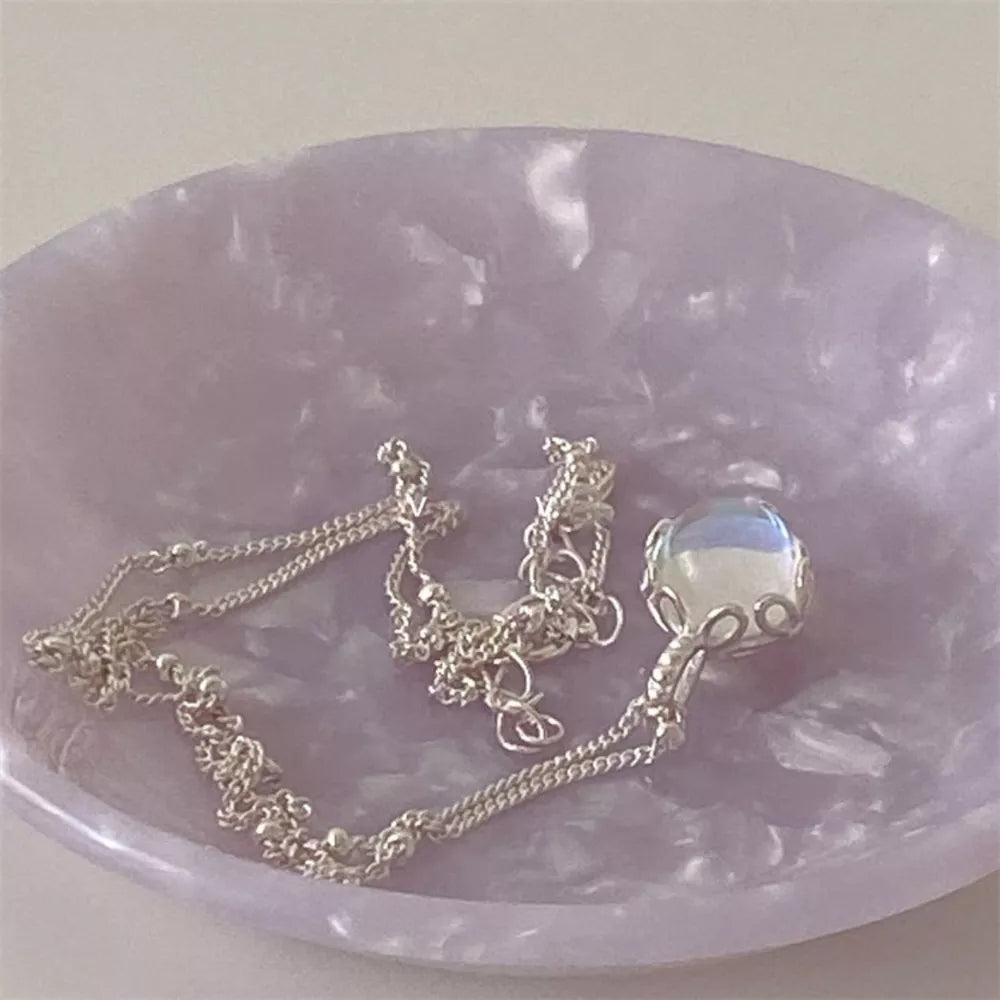Luminous moonstone pendant necklace in 925 sterling silver with blue hues and a delicate chain.