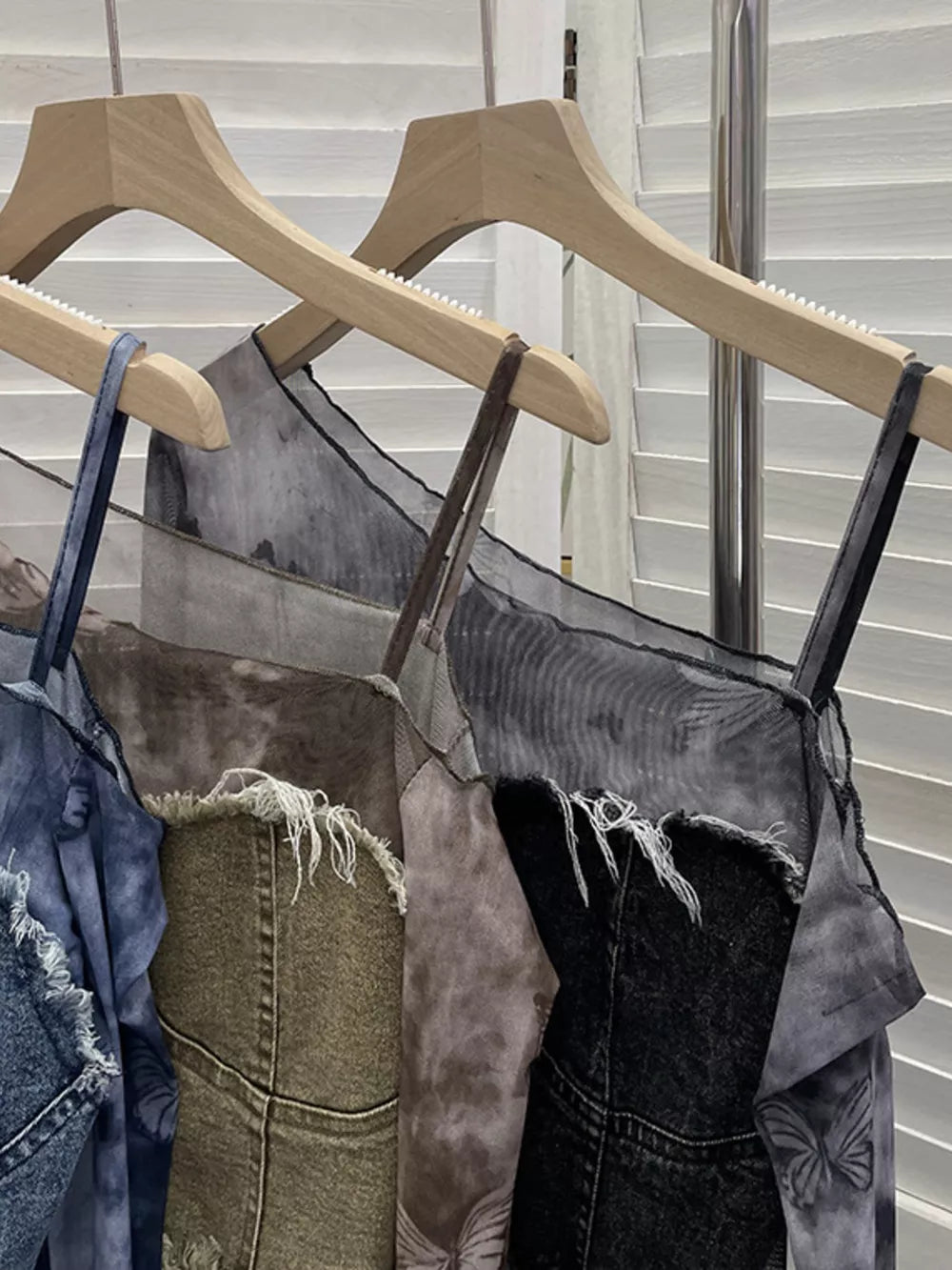 Edgy asymmetrical denim t-shirt with butterfly print and frayed hem in gray black, khaki, and blue.