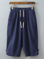 Navy blue cropped sweatpants with drawstring and side pockets.