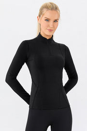 Black athleisure zip-neck top with seam details and long sleeves