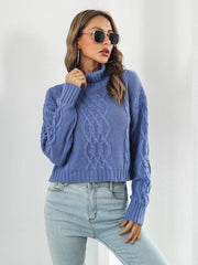 Blue cable knit cropped turtleneck pullover sweater with chunky knit details.