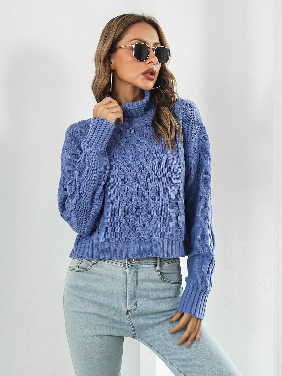 Blue cable knit cropped turtleneck pullover sweater with chunky knit details.