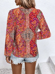 Bohemian paisley v-neck shirt in multicolor with long sleeves, styled with denim shorts.