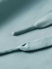 Men's turquoise drawstring active pants detail showing fabric texture and drawstring ends.