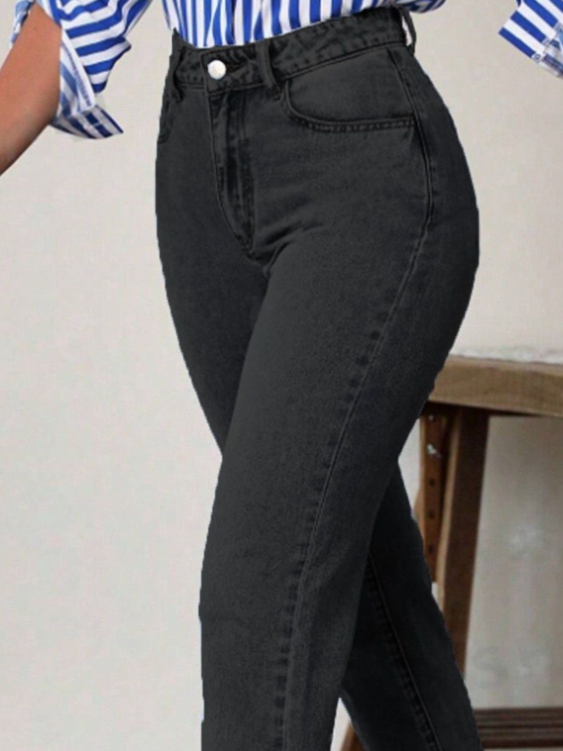 Black slim-fit ankle denim jeans with a modern silhouette.
