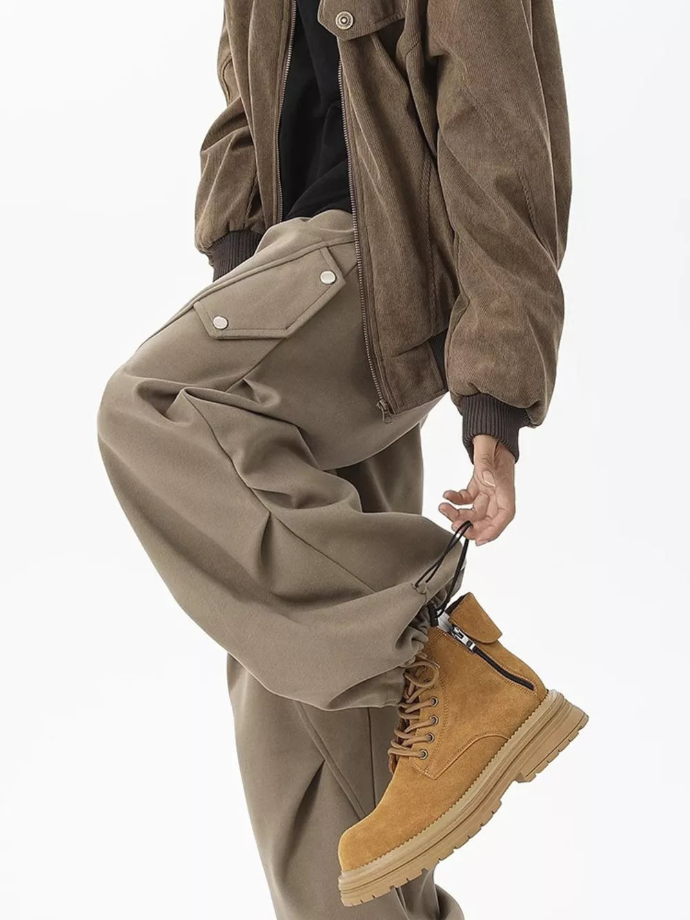 Khaki cargo sweatpants with snap-button pockets and adjustable drawstring cuffs.