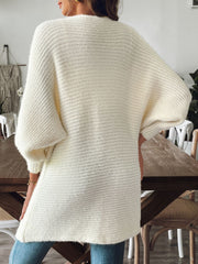 Cream ribbed knit cardigan with dolman sleeves and a relaxed fit.