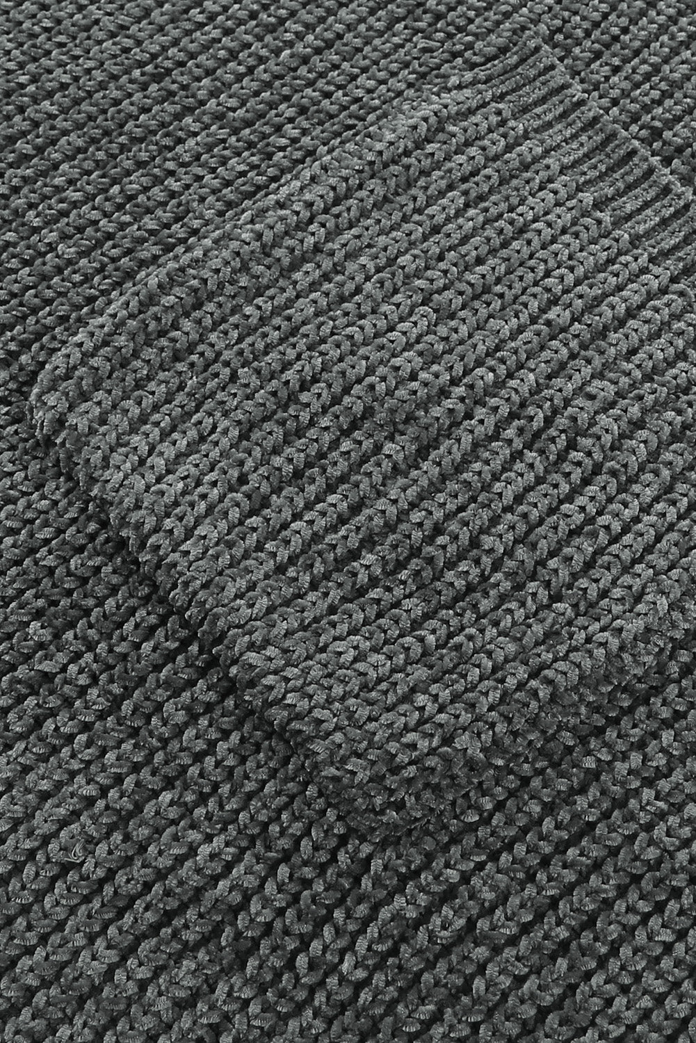 Distressed knit sweater in dark gray with a textured pocket detail.