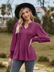 Fuchsia pleated yoke blouse with shirred cuffs and V-neck.