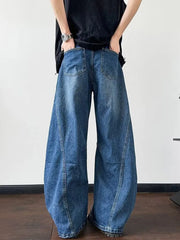 Distressed dark blue wide-leg jeans with a casual, oversized fit.