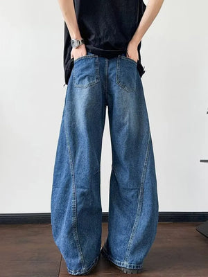 Distressed dark blue wide-leg jeans with a casual, oversized fit.