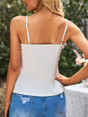 White camisole blouse with adjustable spaghetti straps and square neckline.