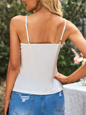 White camisole blouse with adjustable spaghetti straps and square neckline.