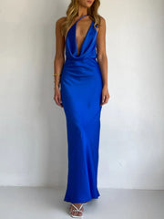 Blue satin asymmetric halter maxi gown with a plunging neckline and body skimming fit.