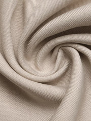 Elegant wide-leg romper fabric detail in beige with subtle texture and draped folds.