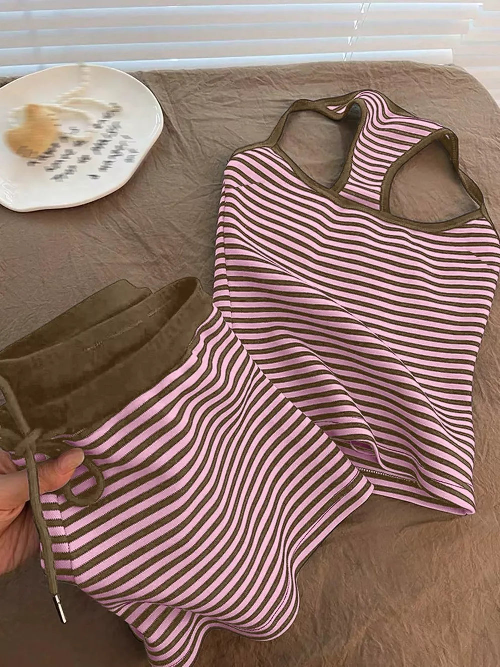 Pink and brown striped loungewear set with tank top and drawstring shorts.