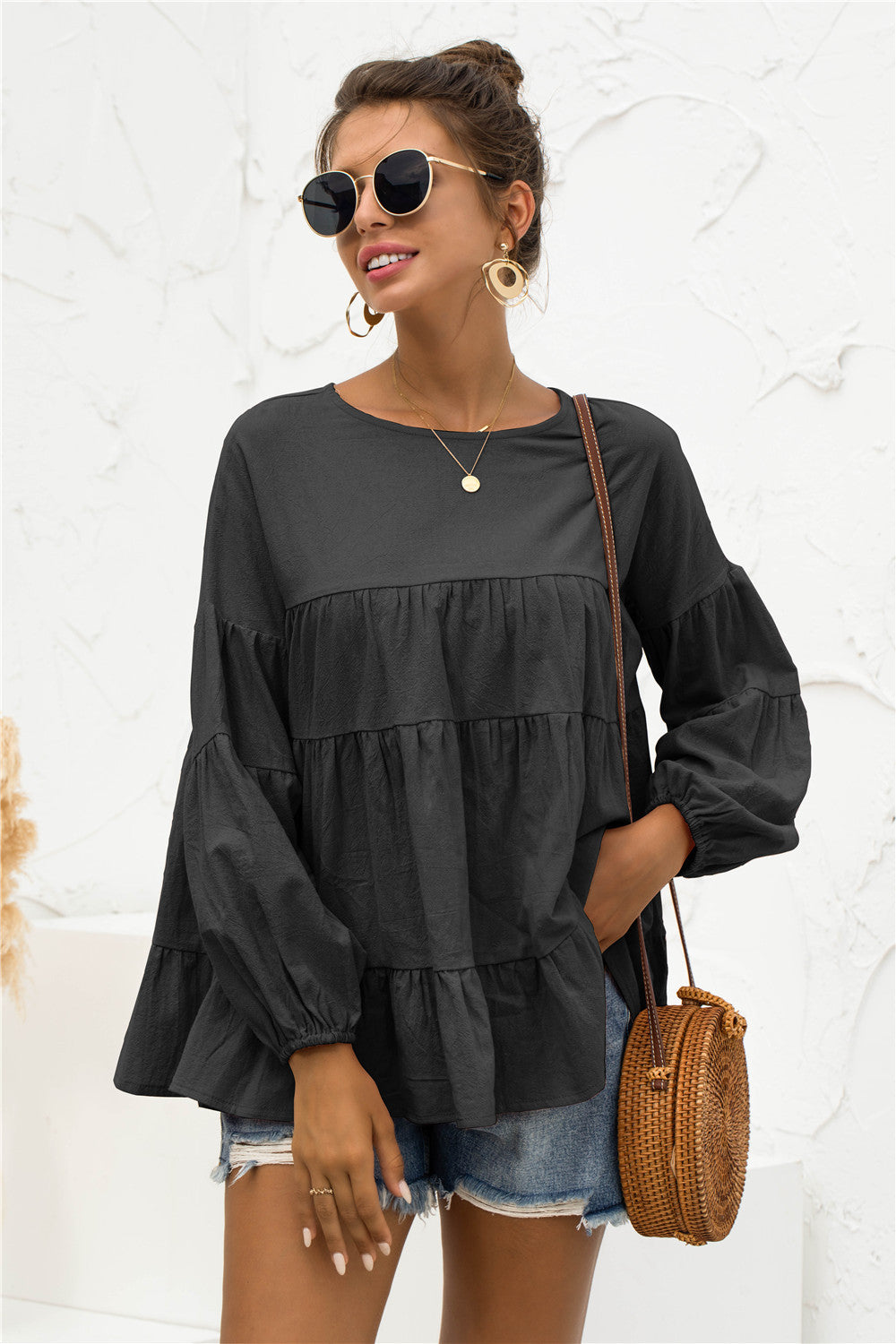 Black tiered peasant blouse with ruffled sleeves and round neckline