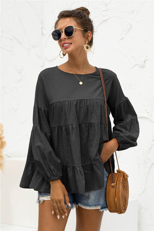 Black tiered peasant blouse with ruffled sleeves and round neckline