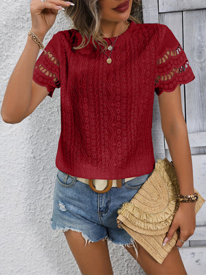 Burgundy eyelet blouse with scalloped short sleeves and intricate textured fabric.