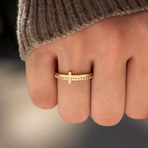Gold-plated ring with a delicate cross and pave crystal band.