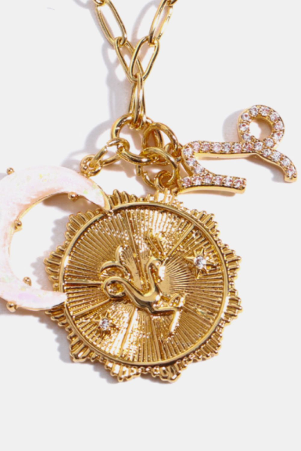 Gold celestial pendant necklace with zodiac symbols and moon charm