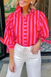 Vibrant puff sleeve stripe shirt in pink and red cotton blend with button-down front.