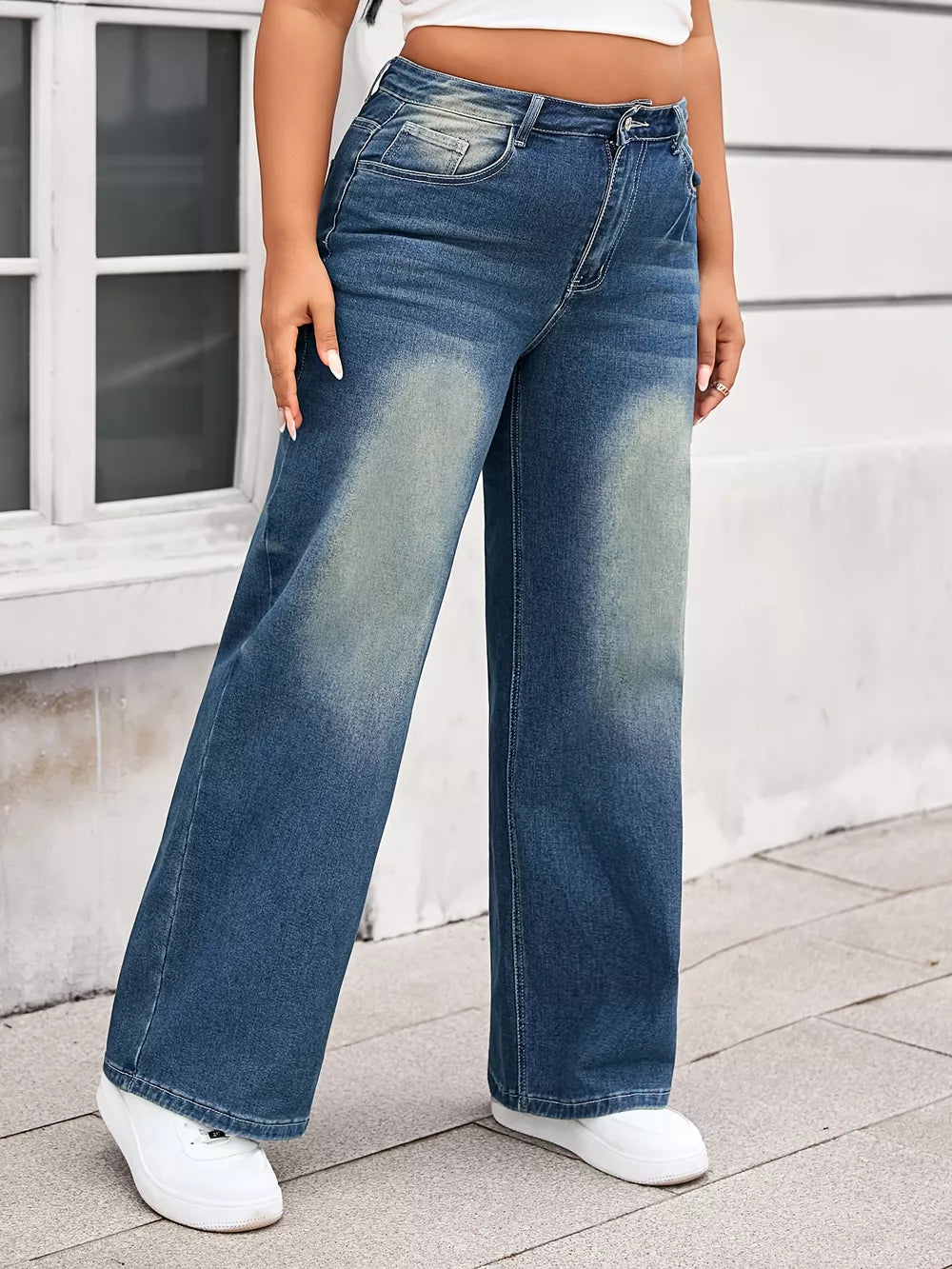 Plus size wide leg blue denim jeans with vintage wash and comfortable fit.