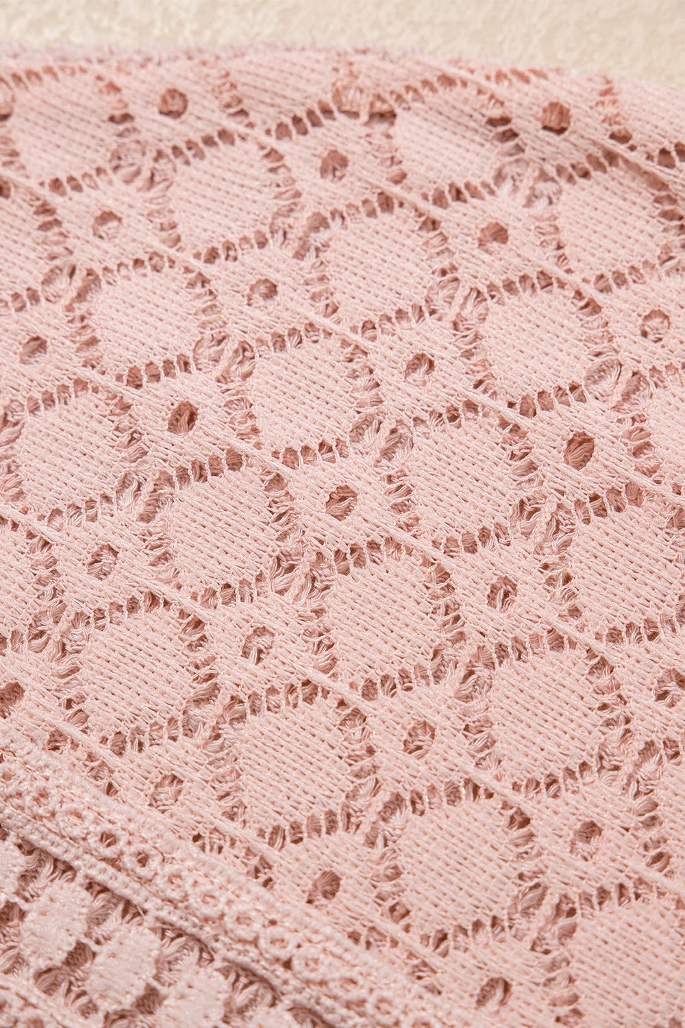 Dusty pink waffle knit lace yoke top detail with intricate circular pattern.