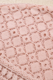 Dusty pink waffle knit lace yoke top detail with intricate circular pattern.