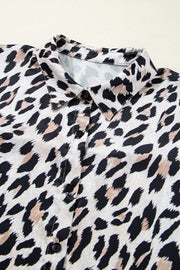 Leopard print oversized button-down blouse with black buttons and a collared neckline.