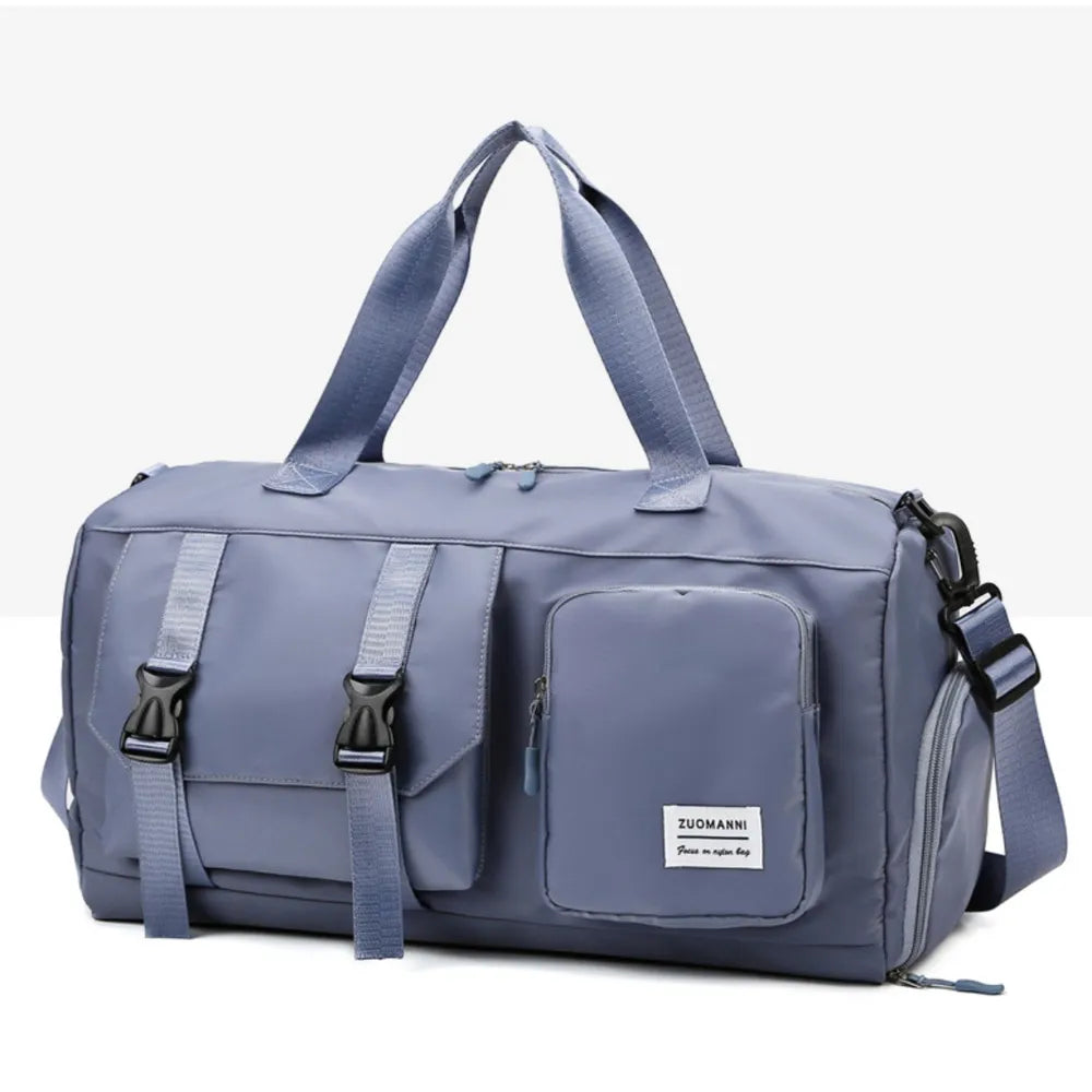 Light Indigo duffel bag with buckle details and multiple pockets.