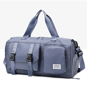 Light Indigo duffel bag with buckle details and multiple pockets.